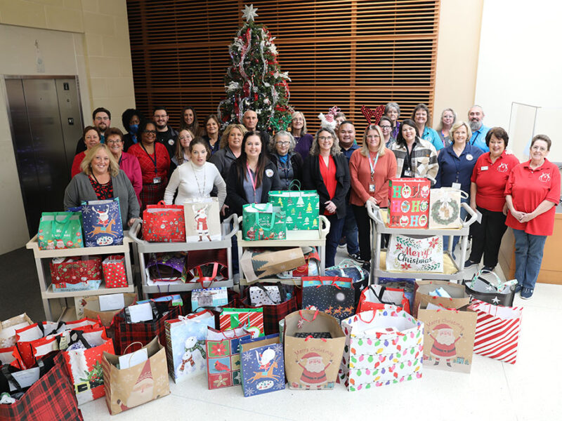 Employees with Lake County Clerk’s Office unwrap giving spirit for those in need